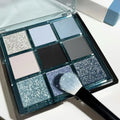 Nine-colour eye shadow palette with blue smoked shades showing matte and shimmer finishes