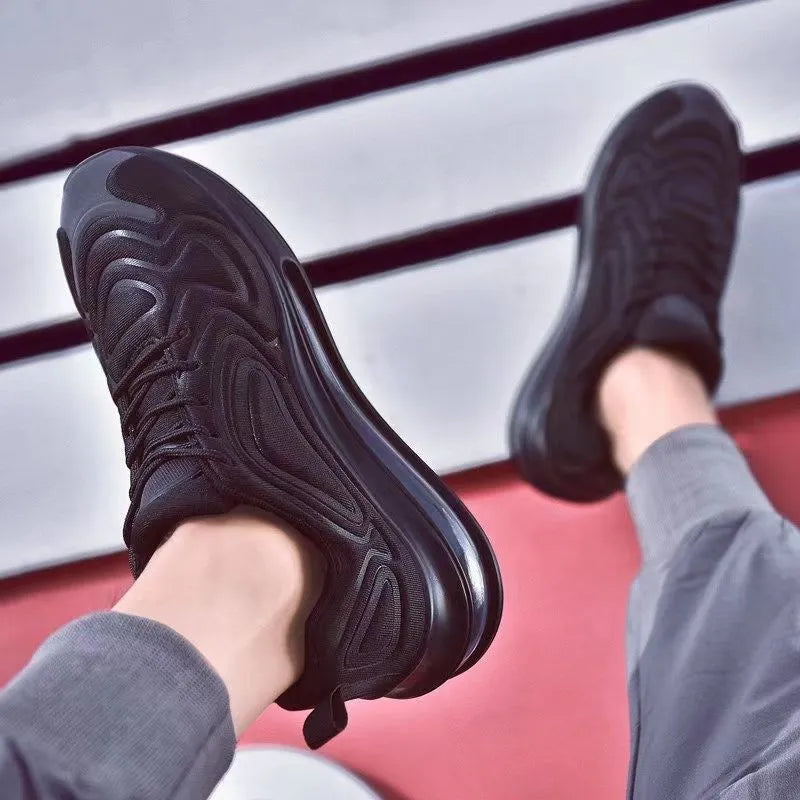 Men's black casual sneakers with lace-up front, thick sole, and round toe for running and outdoor sports.