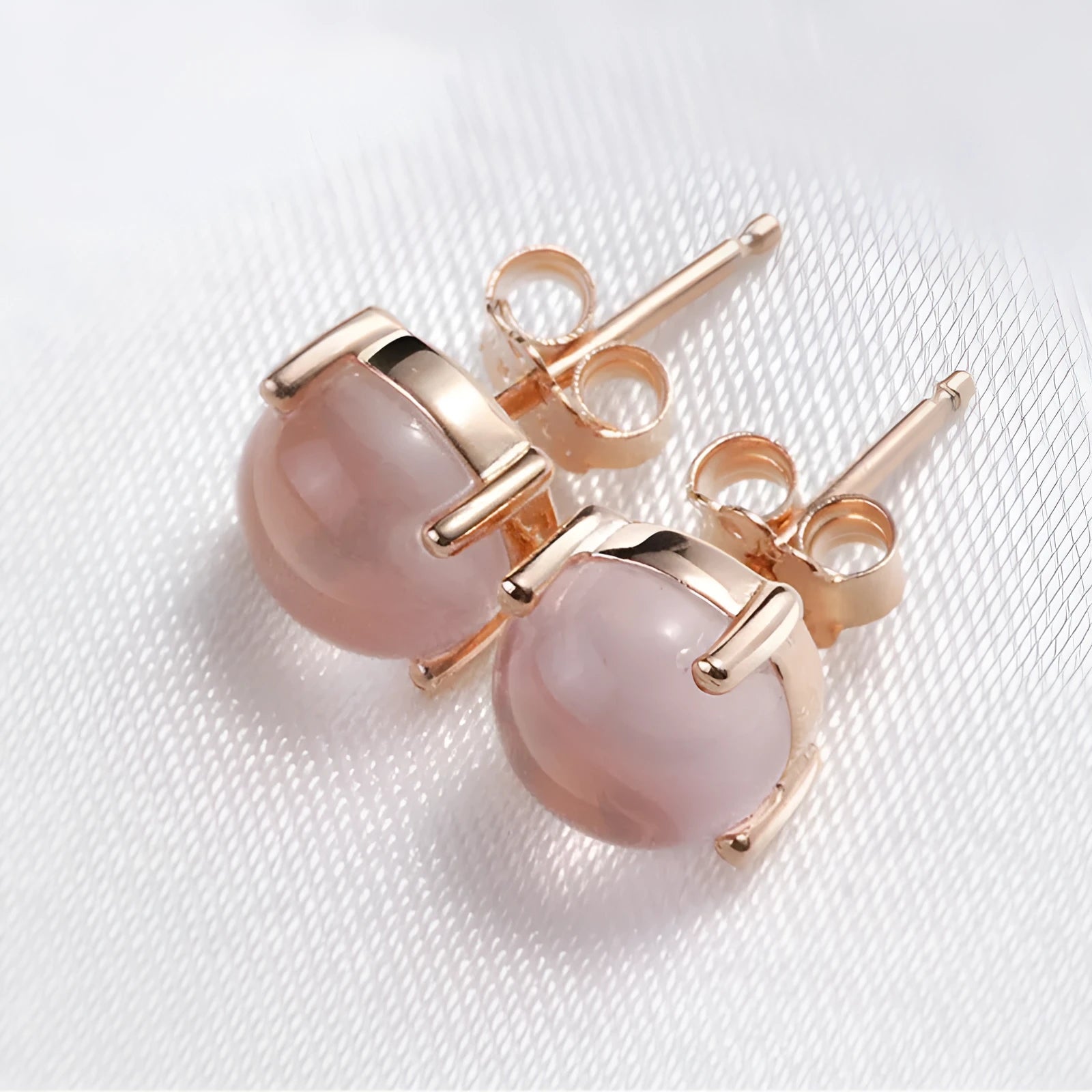 Women's rose gold Korean style stud earrings with synthetic ross quartz crystal inlay in drop shape