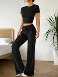 Black high waist trousers and short sleeve t-shirt women's co-ord set on a hanger