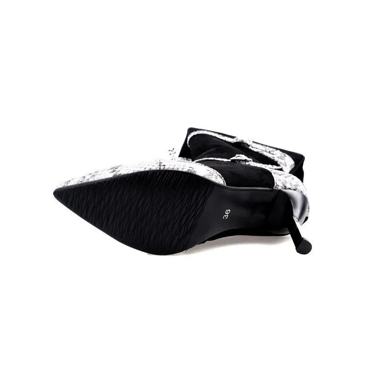 Women's grey knee-high boots with thin high heels on a wooden floor