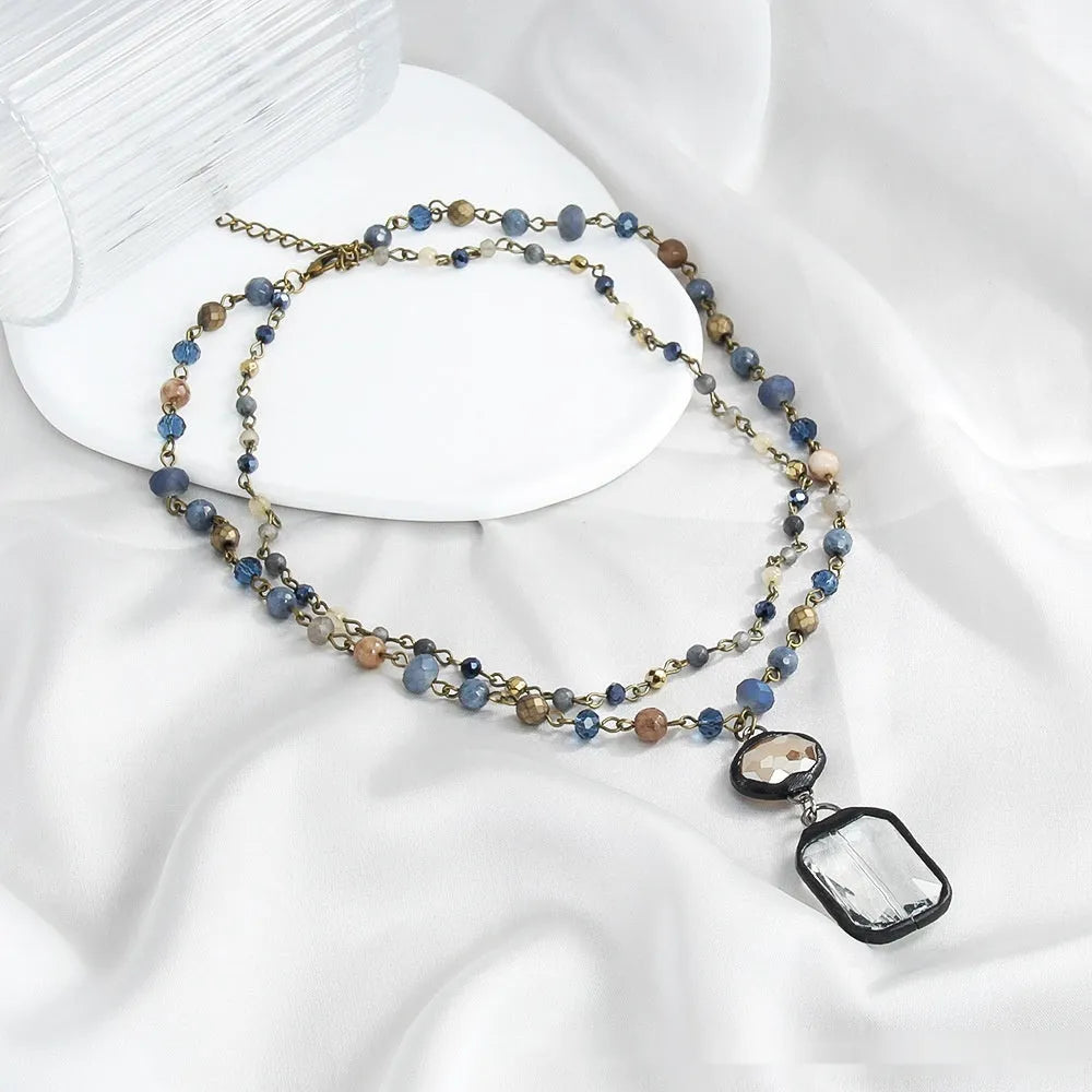 Tribal style two-layer chain necklace with stone and glass pendants in beige or blue colours