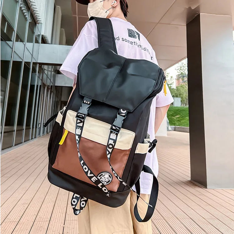 Oxford cloth student backpack shown in black, green, or red with multiple carry straps.