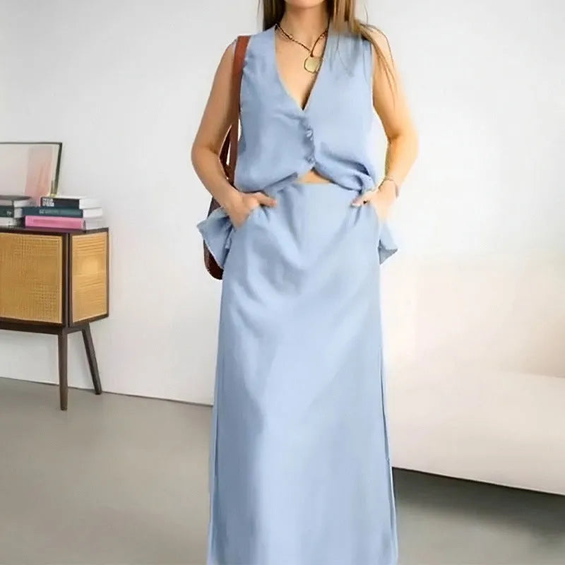 Women's casual white polyester vest and long skirt two-piece suit set on a hanger