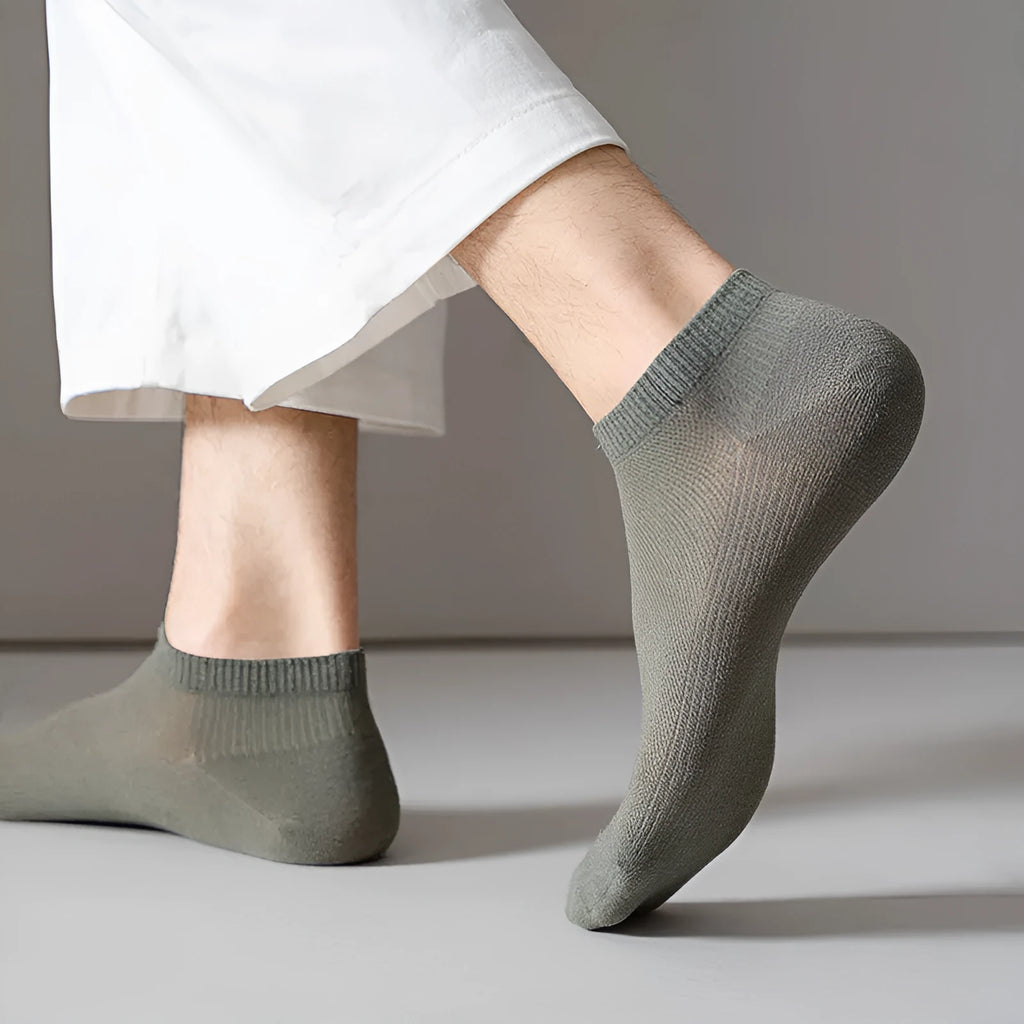 A pair of solid colour low-cut polyester boat socks laid flat.
