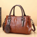 Horizontal square PU leather shoulder bag with contrasting stitching showing internal compartments including mobile phone section