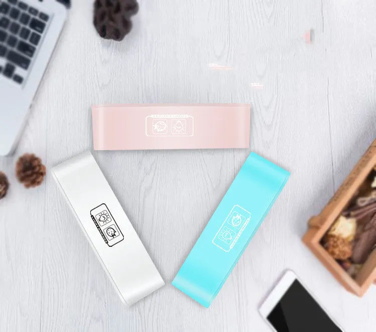 Rectangular blue LED alarm clock with digital display and multicoloured atmospheric lighting on bedside table