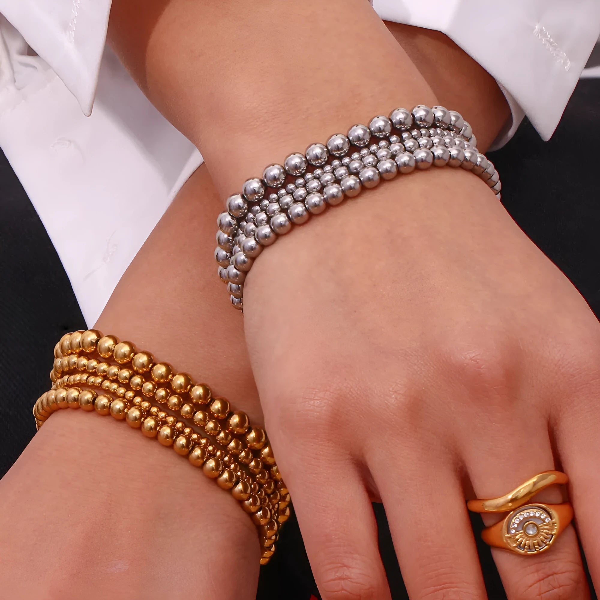 Stainless steel plated elastic bead bracelet with round geometric beads in gold finish
