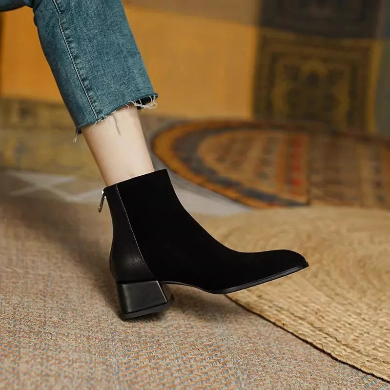 Women's suede martin boots in black with block heel and back zipper on a white background