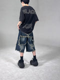 Blue men's loose-fit denim shorts with a frayed five-pointed star detail on the leg, showing American retro style.