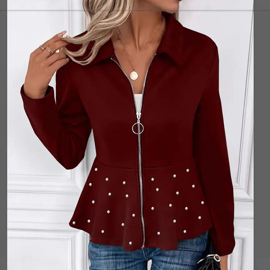 Women's black loose-fit coat with heavy-duty front zipper and ruffle hem detail.
