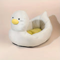 Blue duck-shaped fluffy pet bed sofa for small dogs and cats on a wooden floor.