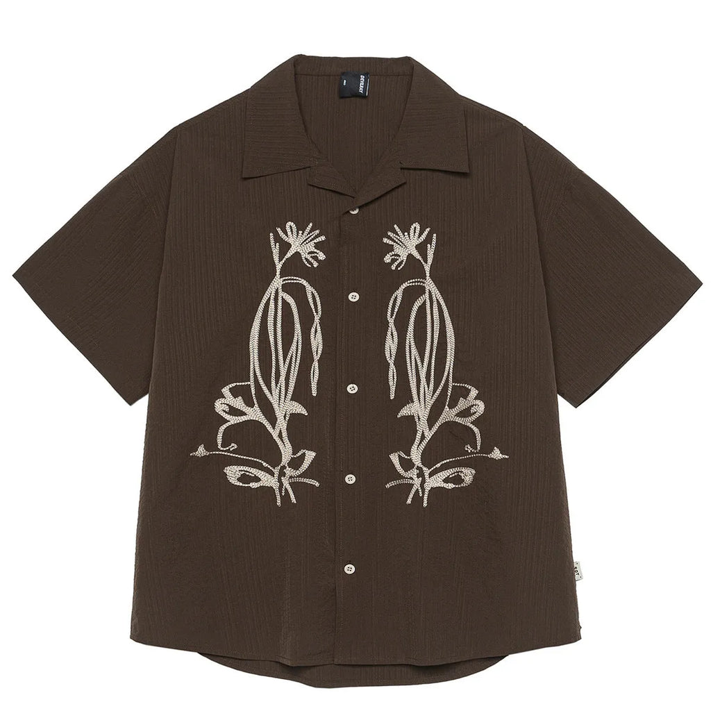 Brown striped short sleeve outdoor shirt with Cuban collar on a mannequin.