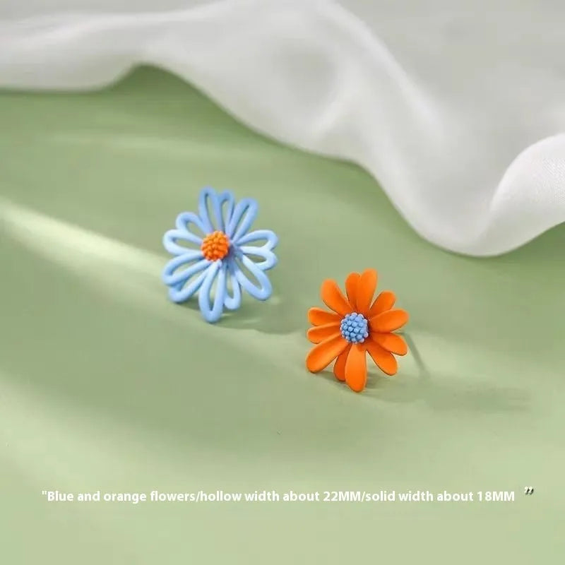 Alloy flower-shaped stud earrings in white and green, yellow and white, and blue orange colour combinations with butterfly clutch fastenings