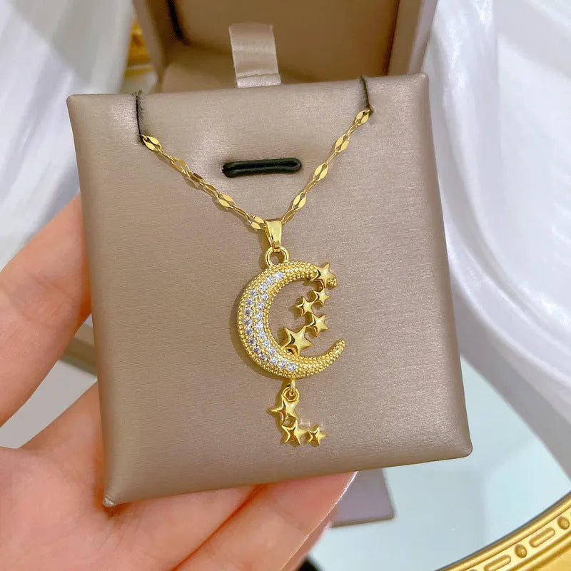 Moon pendant necklace with tassel design and diamond accents on stainless steel chain