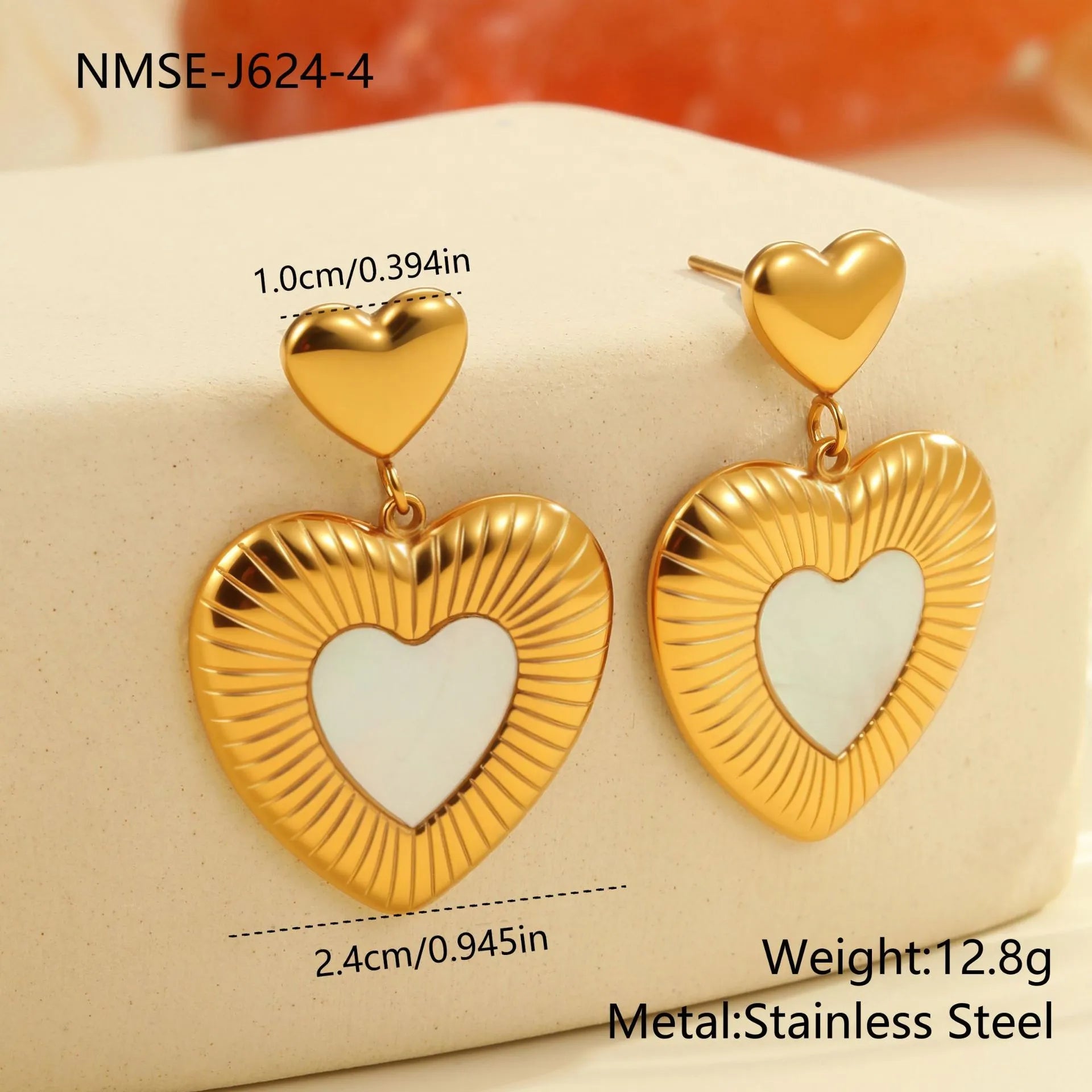 Heart shaped stainless steel earrings with white fritillary pattern and 18K gold electroplated finish