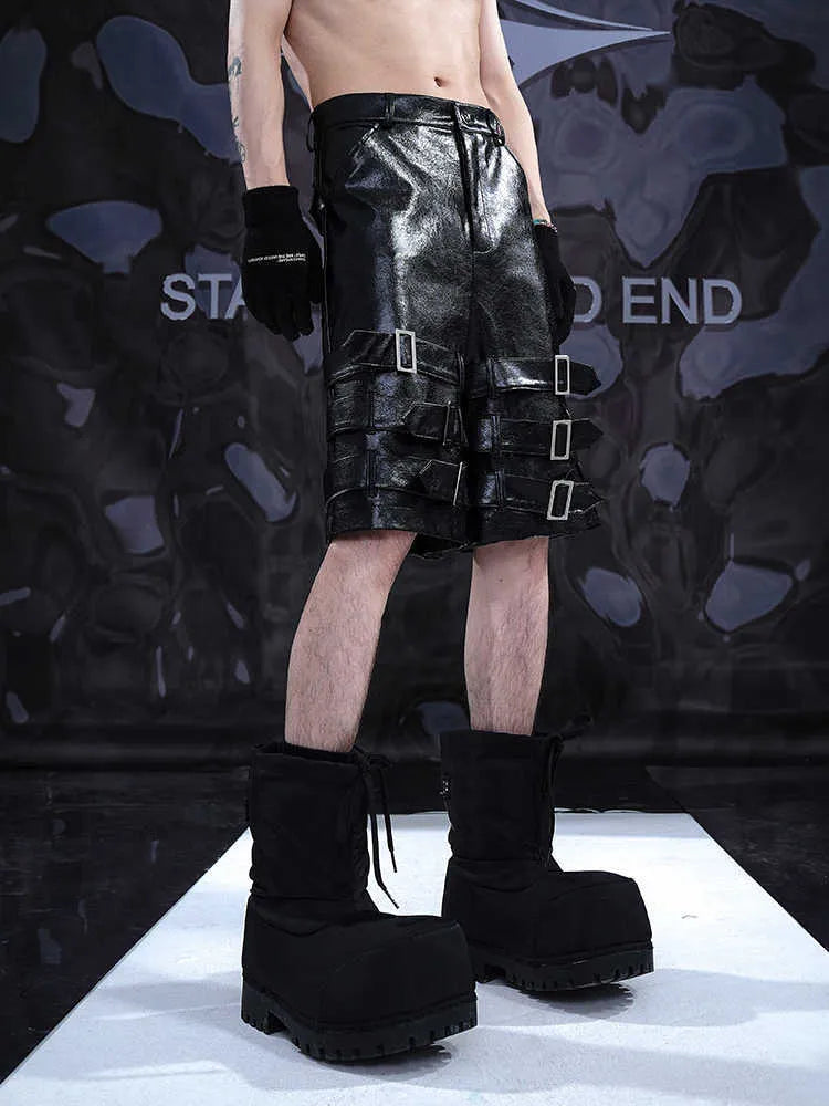 Men's black PU leather casual shorts with a distinctive ring design on the leg, shown in a cropped fit.