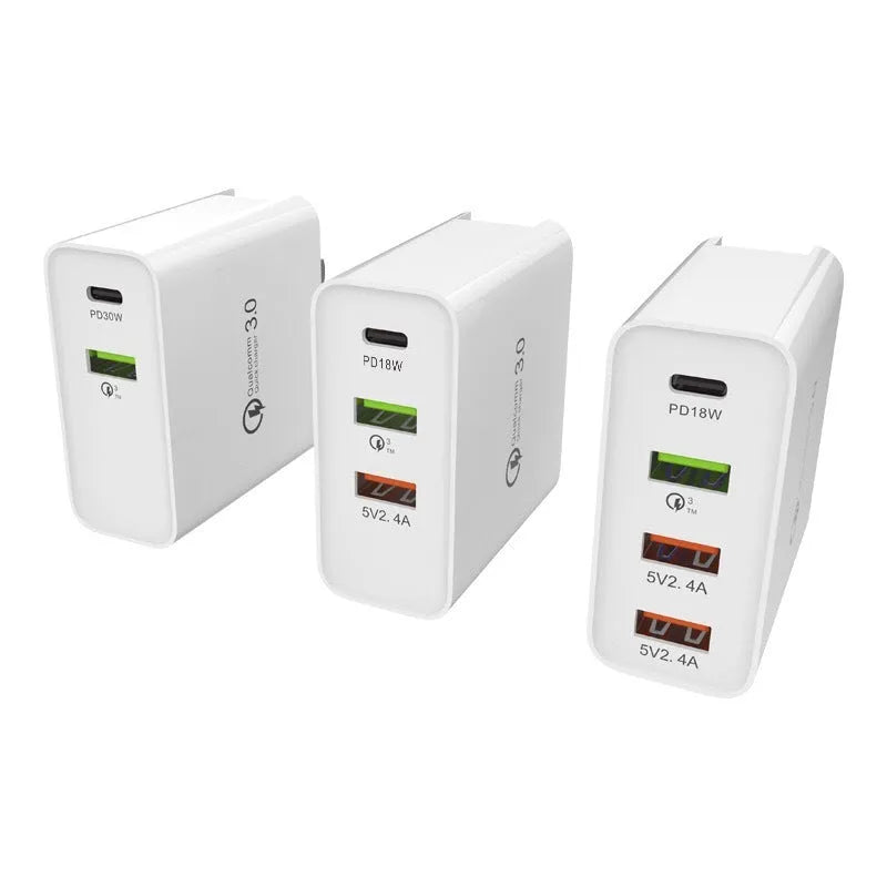 White multi-port USB fast wall charger with PD and QC support on a table.