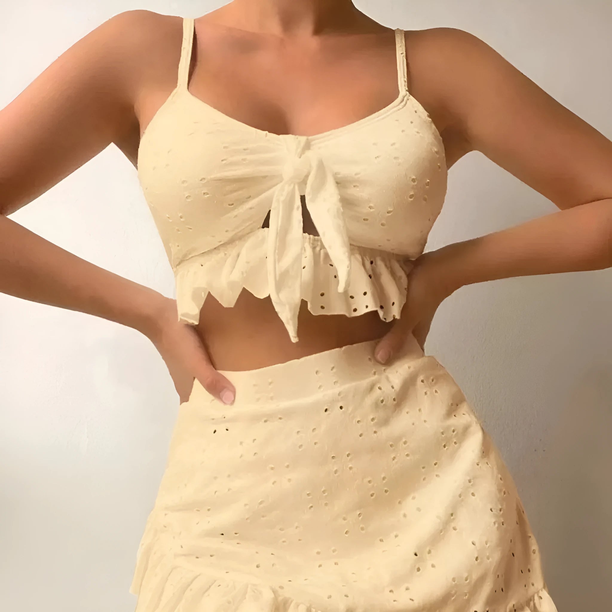 Women's solid colour three-piece bikini swimsuit with a split hip skirt.
