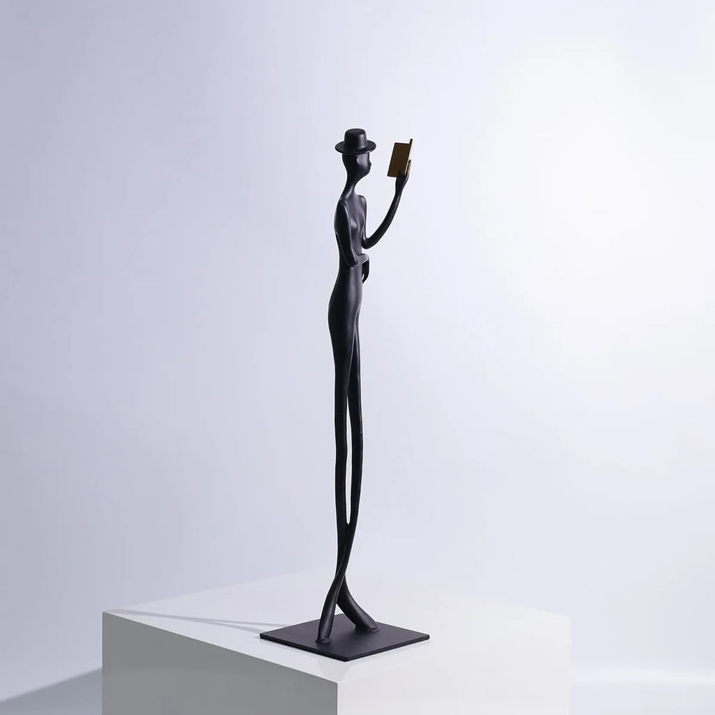 Black cast aluminium desktop sculpture of reading woman figure, modern design
