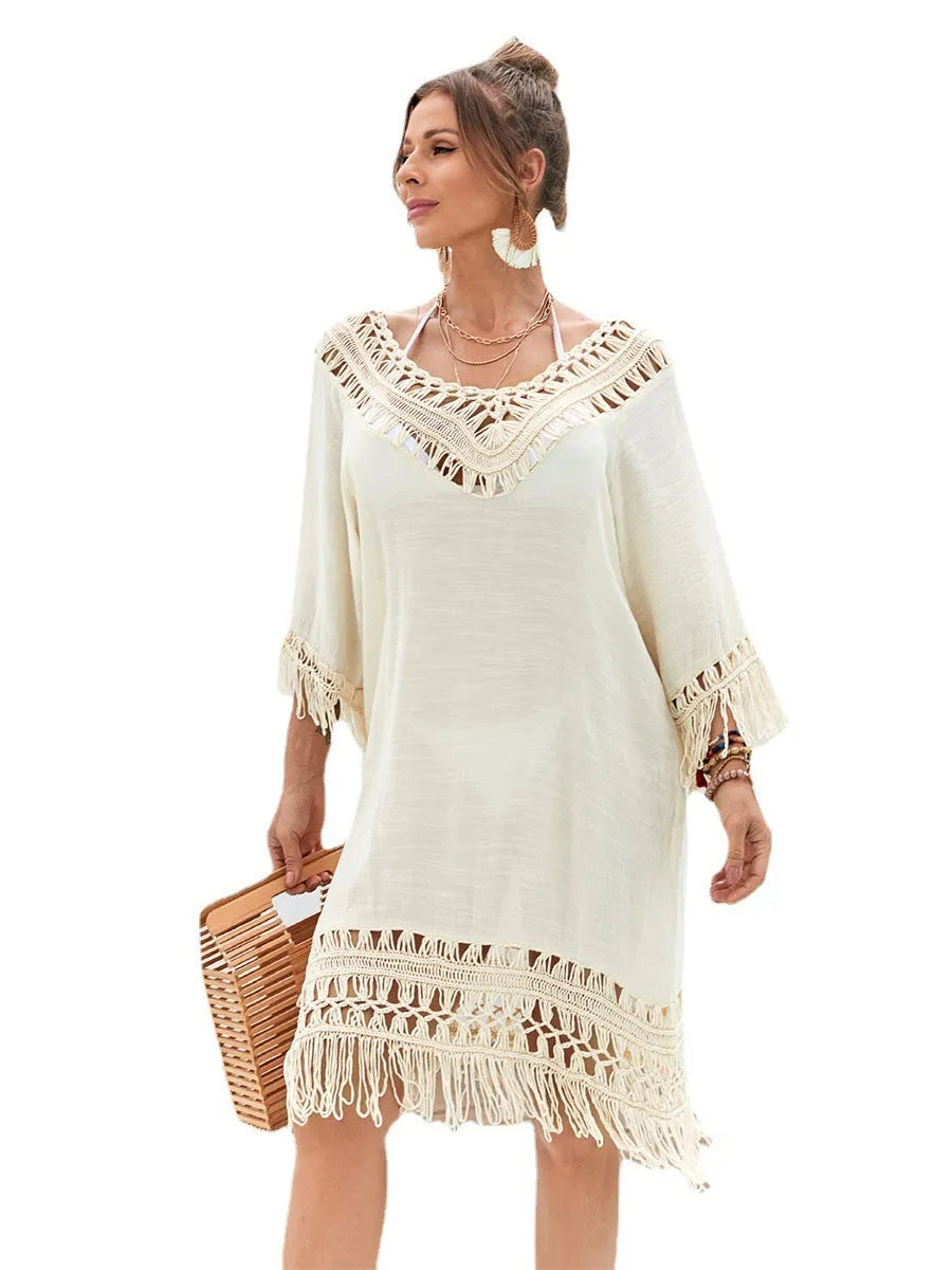 Women's apricot hand-crocheted beach dress with polyester lining shown on hanger