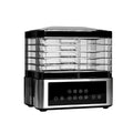 Silver stainless steel fruit dehydrator with six drying trays showing temperature control dial