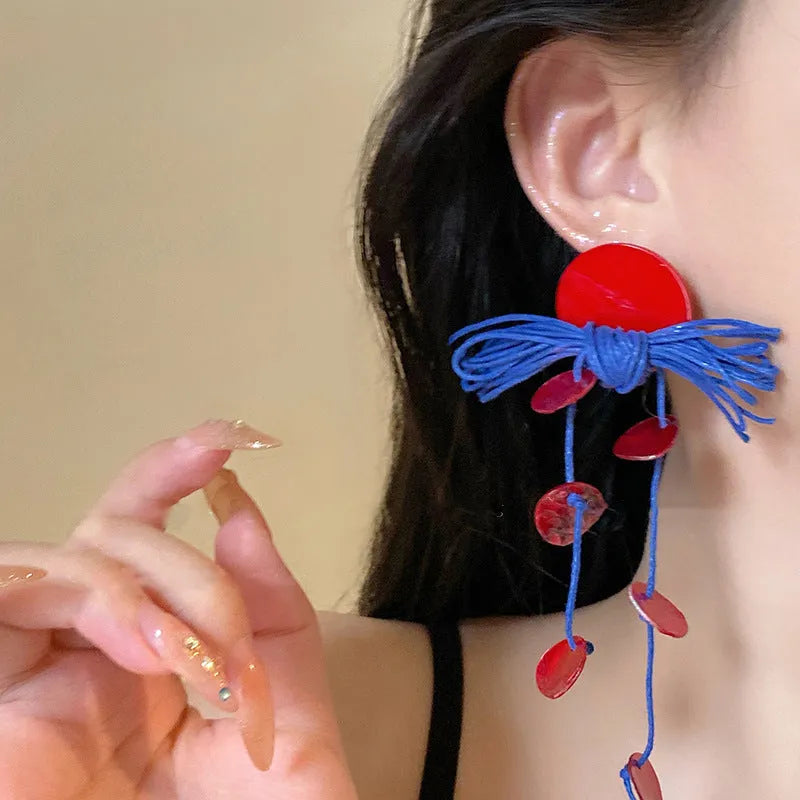 Women's handmade geometric cloth earrings with blue resin flower colour detail