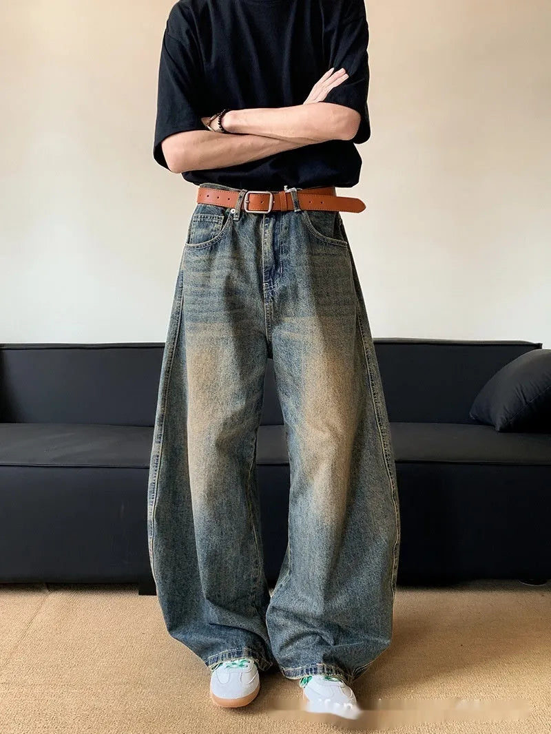 Retro blue distressed machete denim jeans for men with a wide-leg slim cut.