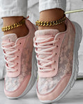 Women's white canvas running shoes with soft sole and round toe on a flat heel.