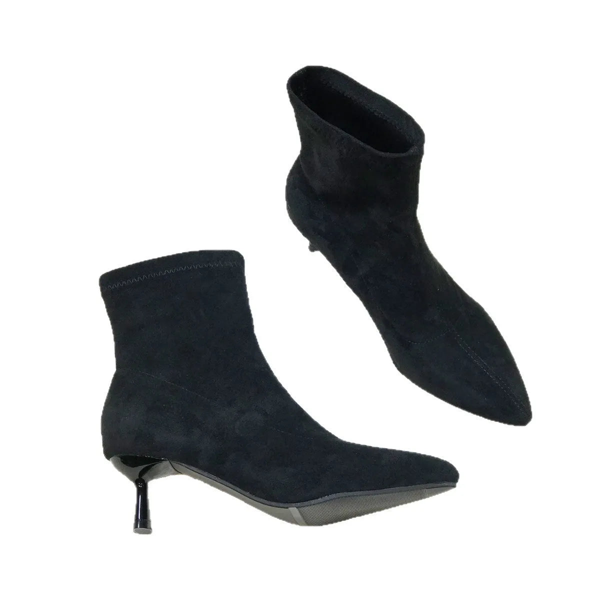Black pointed toe stiletto ankle boots with a mid-calf sock on a plain background.