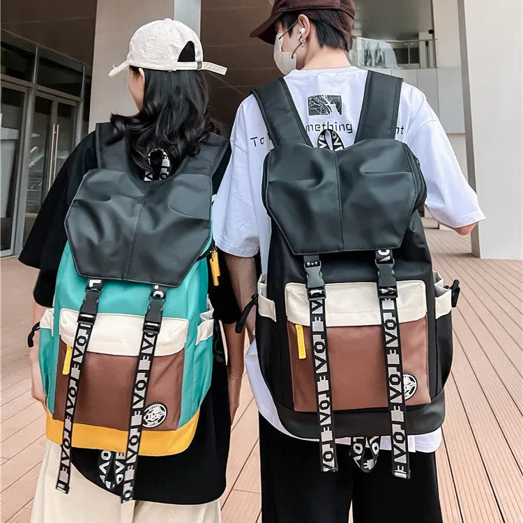 Oxford cloth student backpack shown in black, green, or red with multiple carry straps.