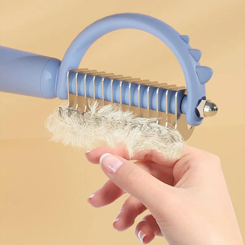 Dinosaur-shaped self-cleaning cat brush with double-sided grooming functions in blue colour