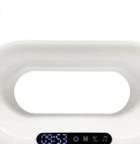 White 3-in-1 LED night light with wireless charger and alarm clock on a bedside table, 23.8cm tall