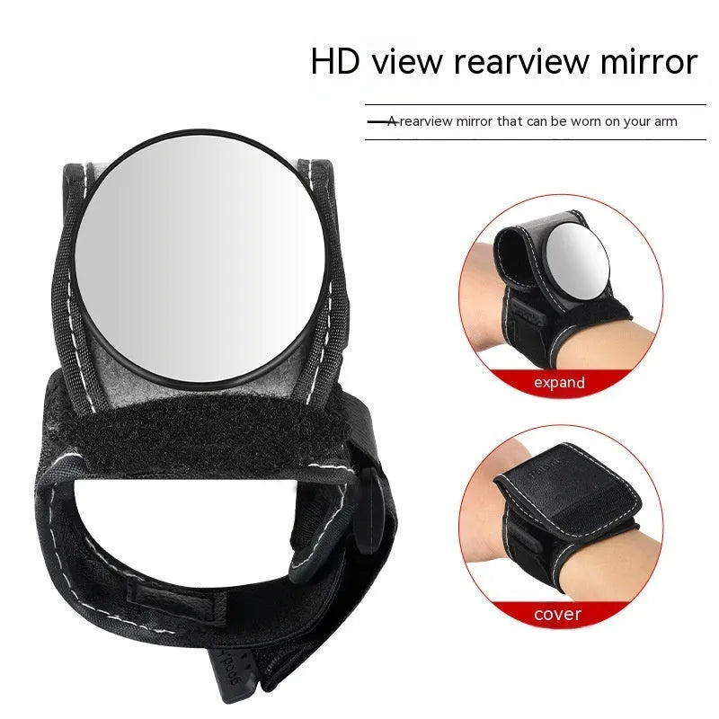 Black bicycle rear-view mirror mounted on an adjustable nylon wrist strap for cycling.