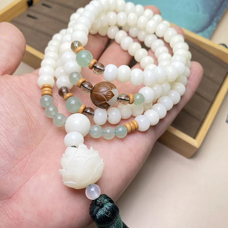 White Jade Bodhi stone beaded bracelet with 108 beads on a wrist.