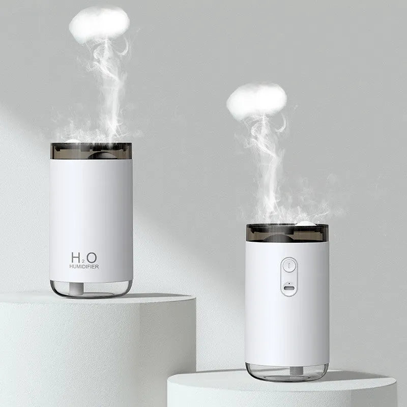 White jellyfish USB humidifier with night light on wooden surface showing mist output