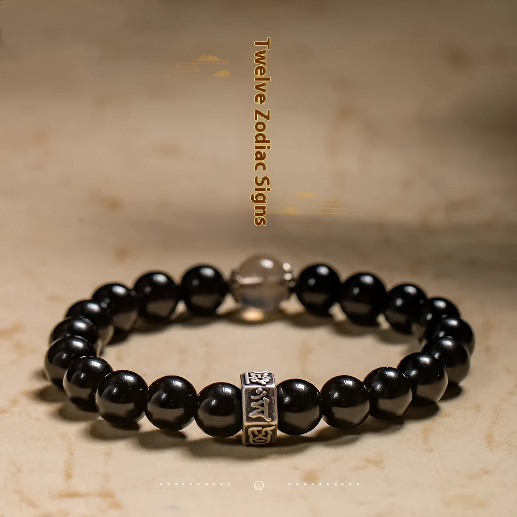 Obsidian bracelet with 8mm beads carved with zodiac animals and bodhisattva figures.