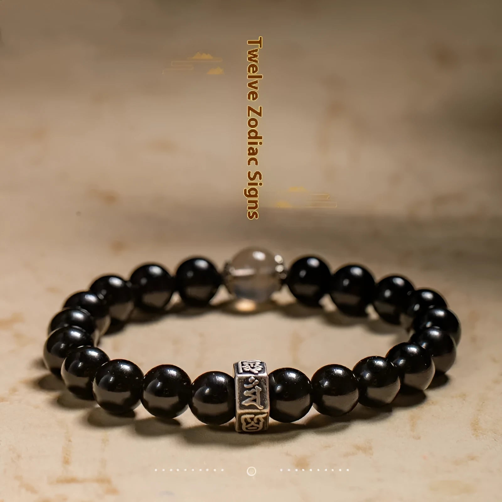Obsidian bracelet with 8mm beads carved with zodiac animals and bodhisattva figures.