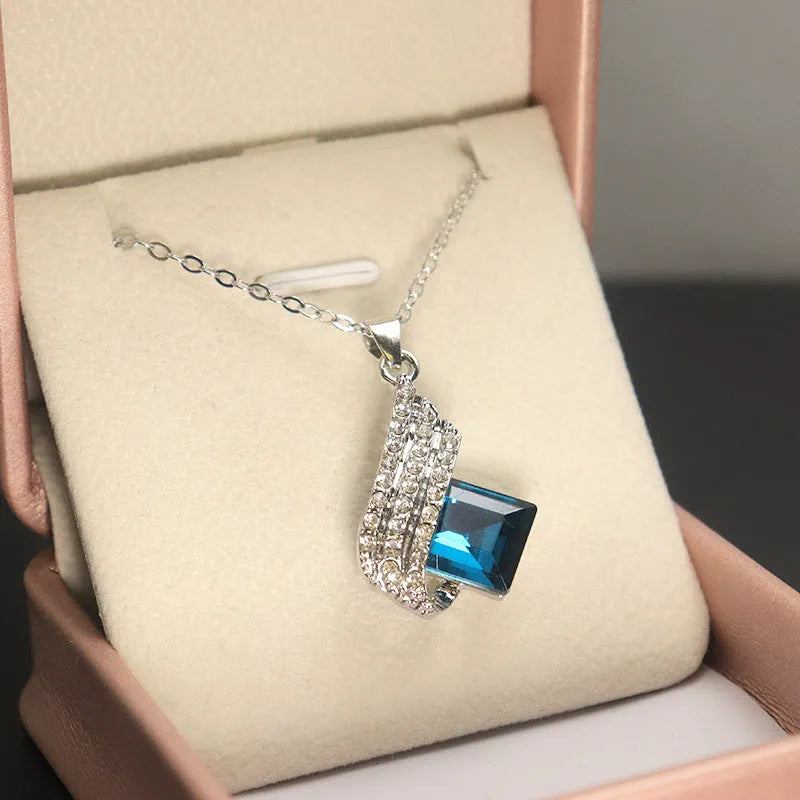 Women's necklace and earring set with glass pendant on cross chain, alloy material with electroplated finish