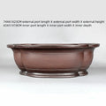 Large antique crabapple-shaped handmade purple clay flowerpot for plants.