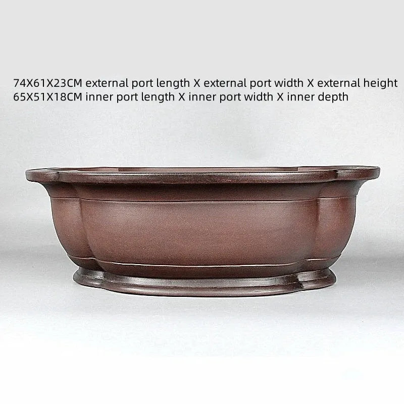 Large antique crabapple-shaped handmade purple clay flowerpot for plants.
