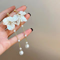Women's acrylic shell pearl tassel earrings showing 8.8cm drop length and cushion ear clip option