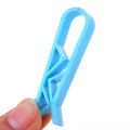 White PP plastic non-slip clip for holding a garbage bag onto a rubbish bin.