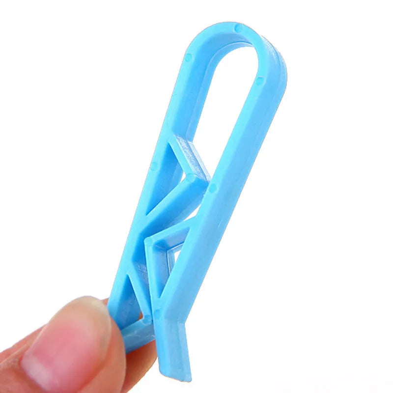 White PP plastic non-slip clip for holding a garbage bag onto a rubbish bin.