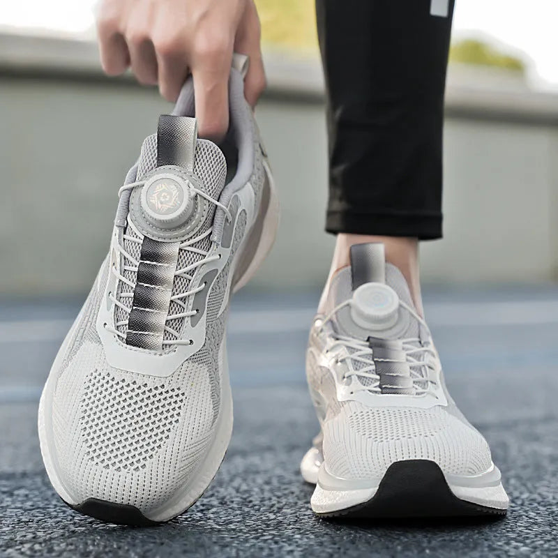 Men's white low-top running shoes with a rotating button buckle and breathable mesh upper.