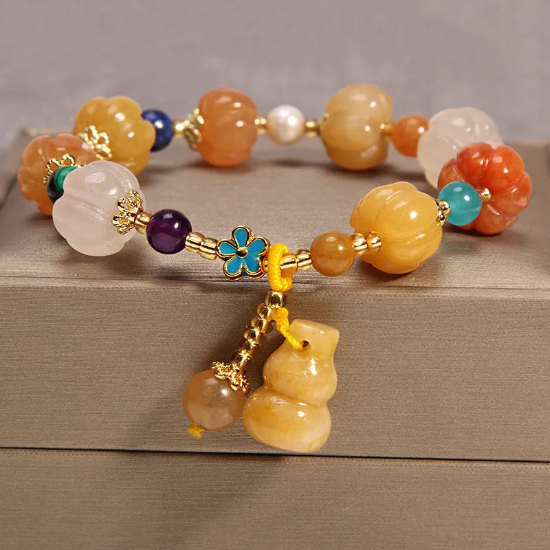 Women's khaki yellow agate crystal bracelet on a gold silk cord.