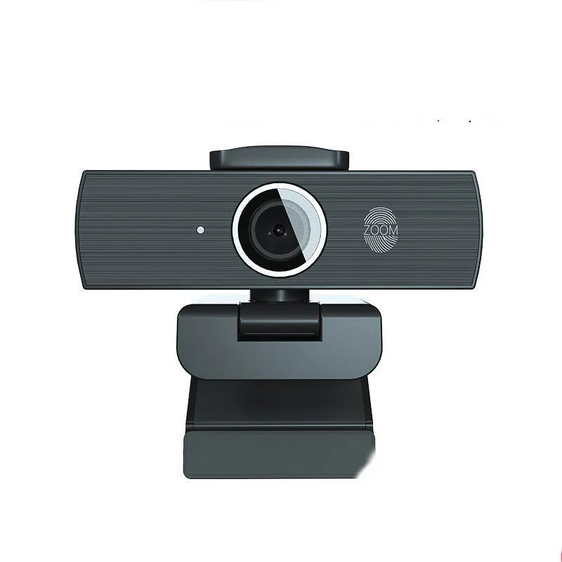 Black 4K USB webcam on a desktop with a magnetic privacy cover next to it