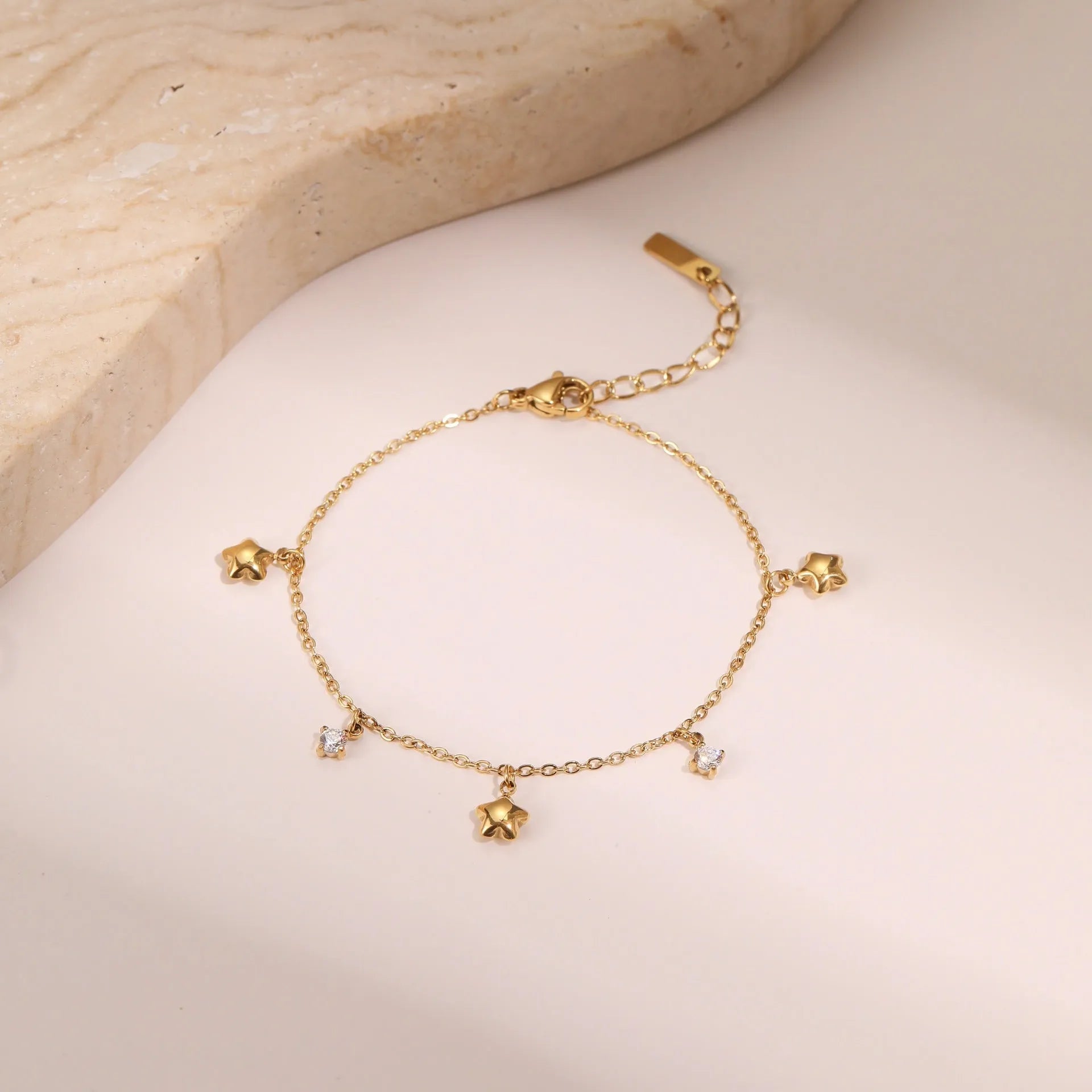 Ins women's gold-plated stainless steel bracelet with a geometric hexagonal star zircon pendant.