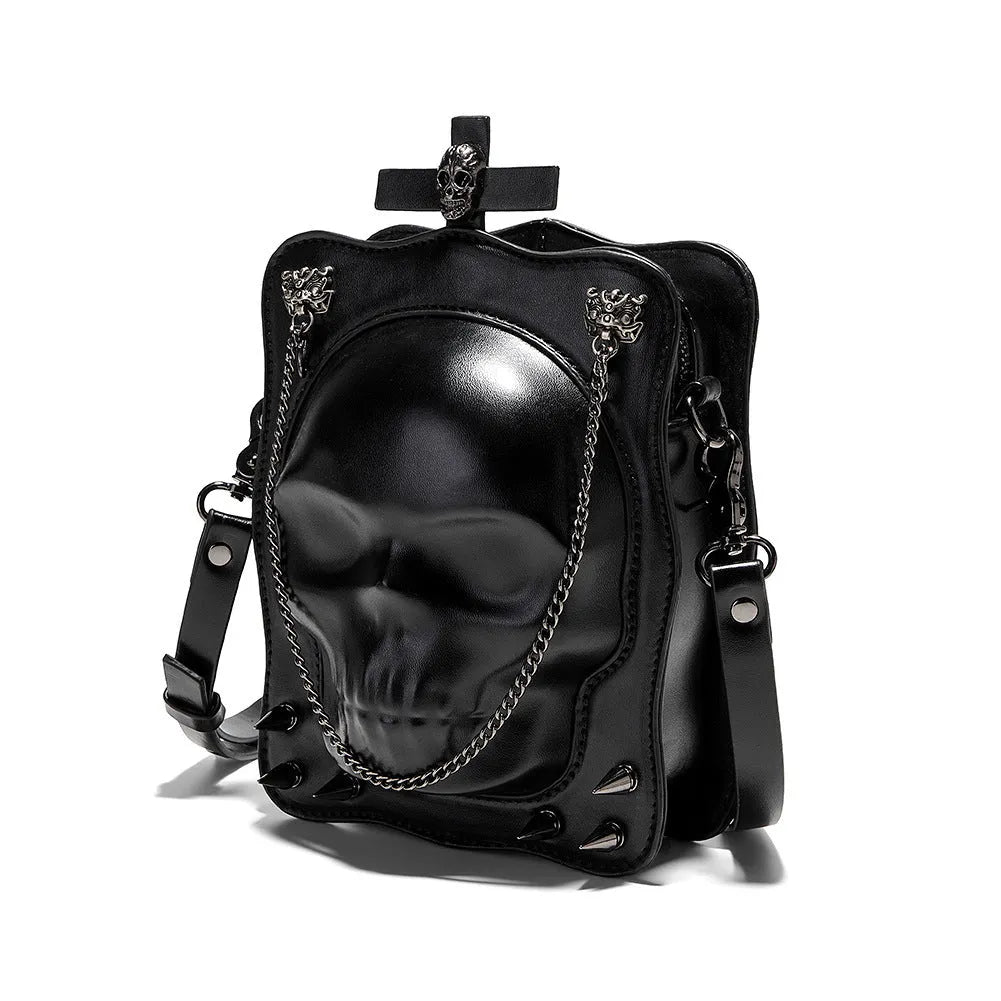 Black gothic crossbody bag with embossed skull design, chain strap and square shape