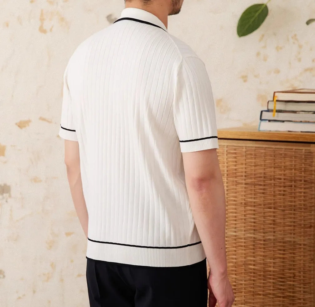 Slim fit lapel collar short-sleeved polo shirt in black, laid flat.